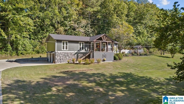 view of front of property with a garage and a front lawn