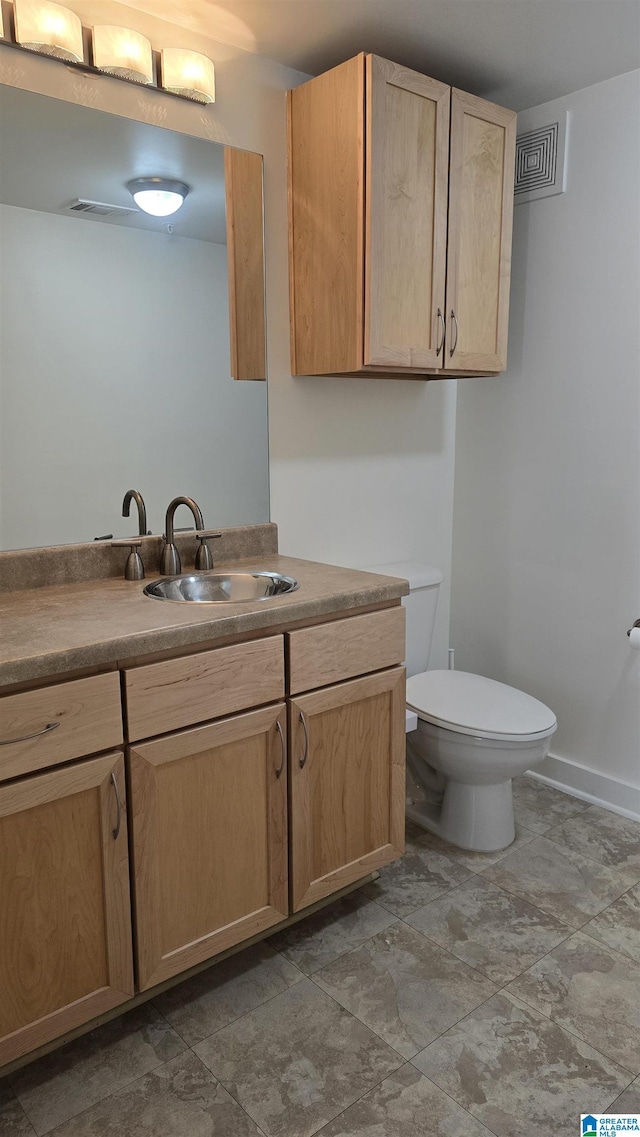 bathroom with vanity and toilet