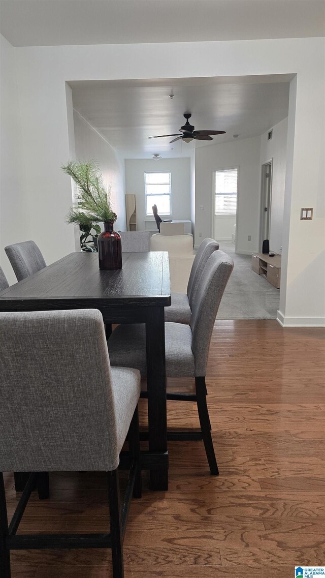 dining room with wood-type flooring and ceiling fan