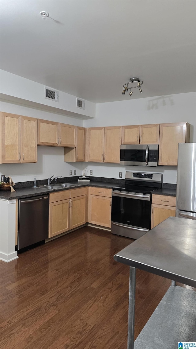 kitchen featuring light brown cabinets, sink, dark hardwood / wood-style floors, and appliances with stainless steel finishes