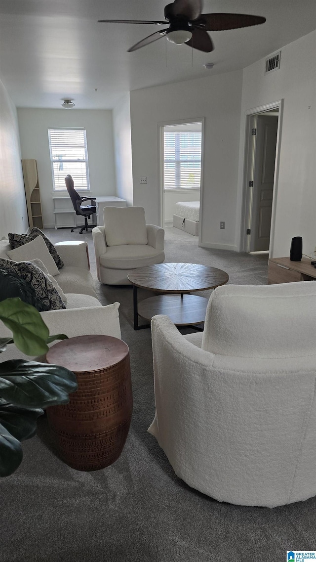 living room featuring carpet floors and ceiling fan