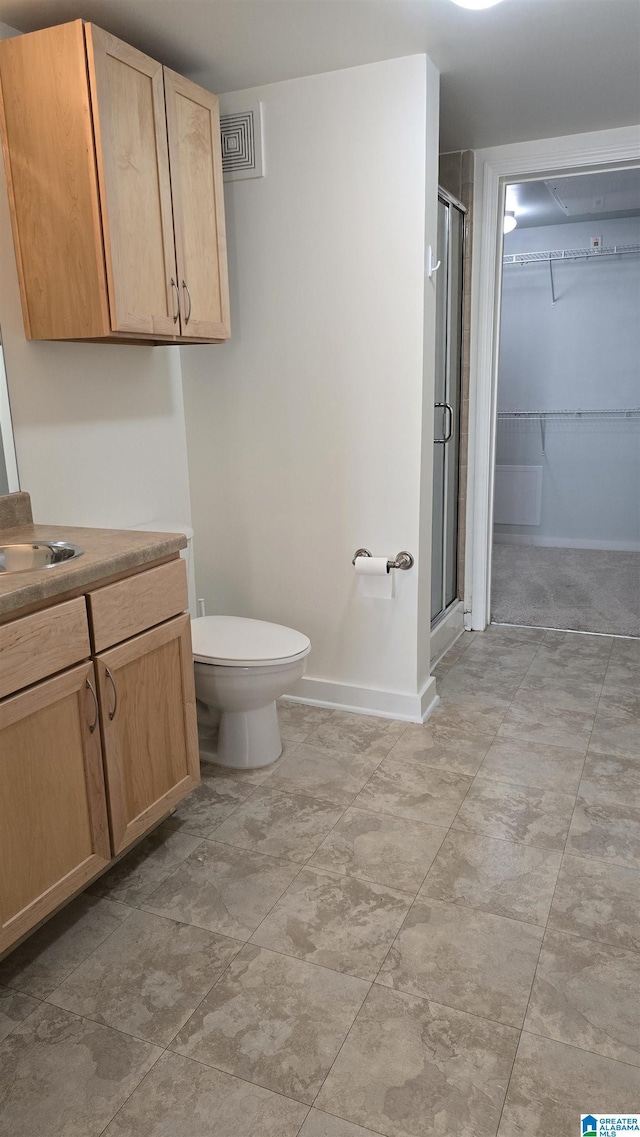 bathroom with vanity, toilet, and walk in shower