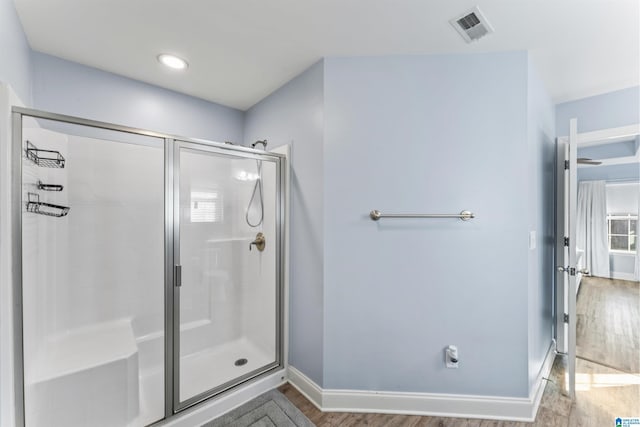 bathroom with wood-type flooring and walk in shower