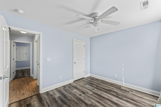 unfurnished bedroom featuring ceiling fan and dark wood-type flooring