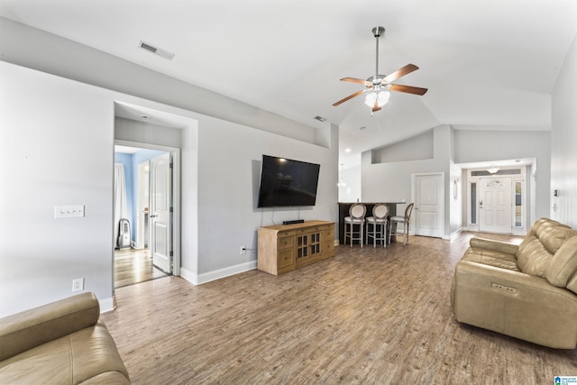 living room featuring ceiling fan, hardwood / wood-style floors, and high vaulted ceiling