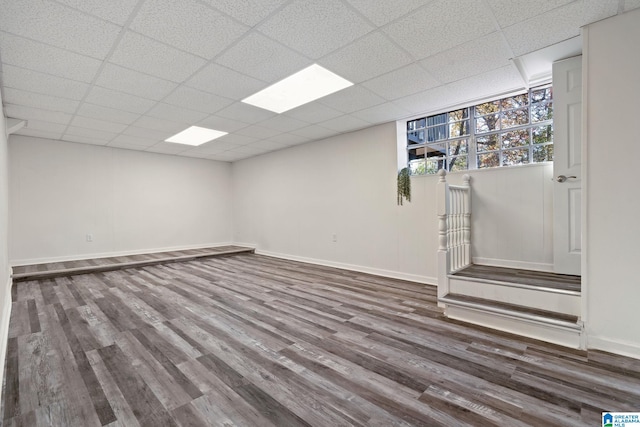 basement featuring hardwood / wood-style floors and a drop ceiling