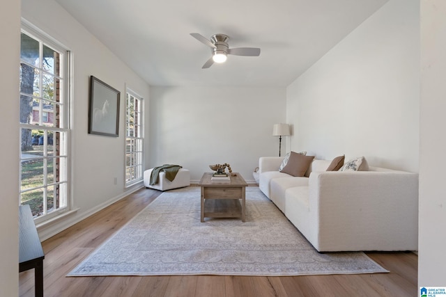 living room with light hardwood / wood-style flooring, a wealth of natural light, and ceiling fan