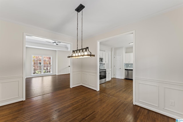 unfurnished dining area with dark hardwood / wood-style flooring, ceiling fan, and crown molding