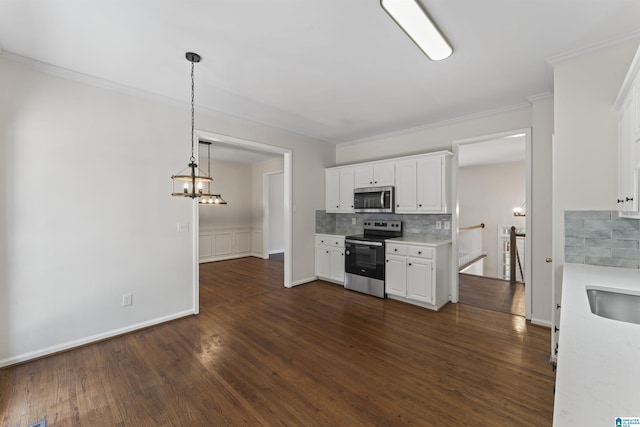 kitchen featuring stainless steel appliances, dark hardwood / wood-style floors, pendant lighting, decorative backsplash, and white cabinets