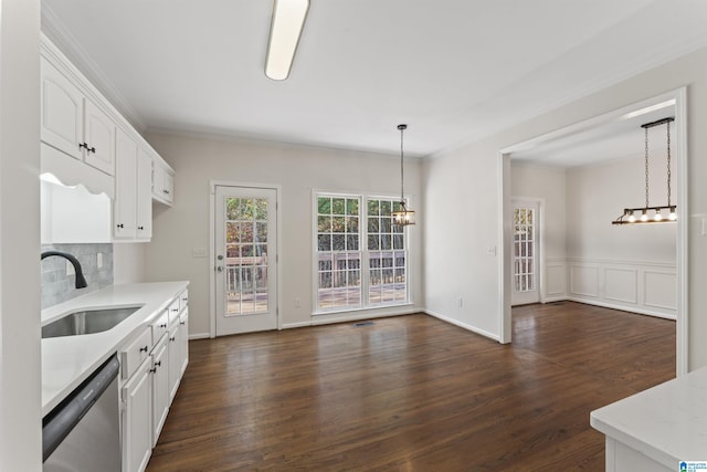 kitchen featuring white cabinetry, dishwasher, sink, and hanging light fixtures