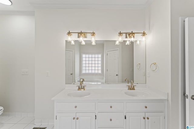 bathroom with toilet, vanity, tile patterned floors, and crown molding