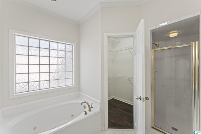 bathroom with hardwood / wood-style floors, ornamental molding, and shower with separate bathtub