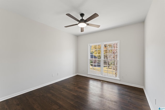 spare room with ceiling fan and dark wood-type flooring