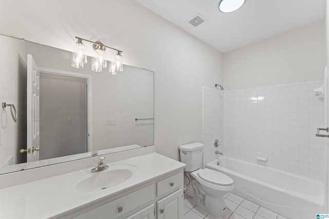 full bathroom with tile patterned flooring, vanity, tiled shower / bath combo, and toilet