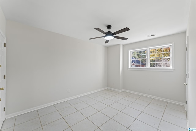 empty room with light tile patterned floors and ceiling fan