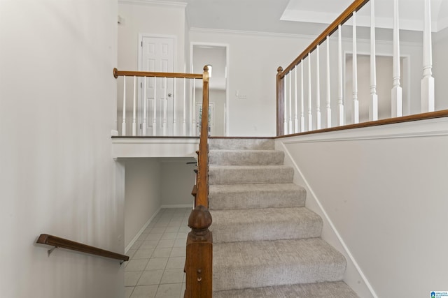 stairway featuring crown molding and tile patterned flooring