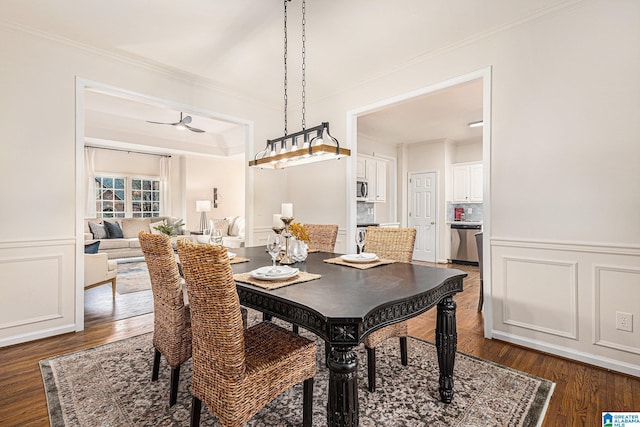 169 Glen Abbey Way, Alabaster, AL 35007 - dining room featuring dark wood-type flooring, ornamental molding, wainscoting, and a decorative wall