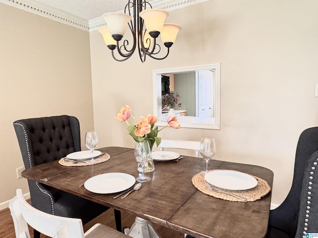 dining area with a chandelier, hardwood / wood-style floors, and a textured ceiling