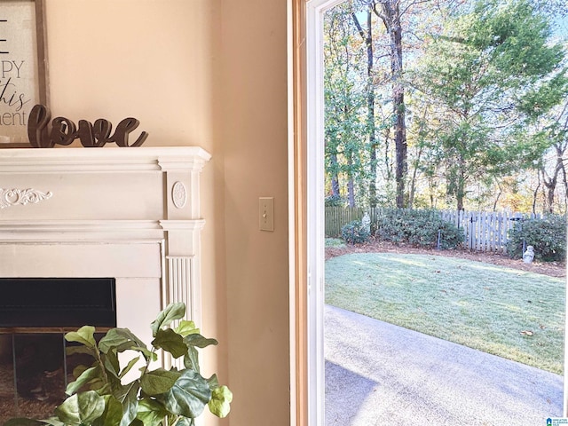 entryway featuring a fireplace and carpet floors