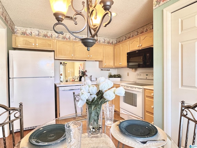 kitchen featuring light brown cabinets, white appliances, a textured ceiling, and wood-type flooring