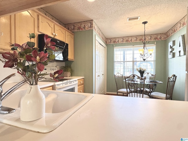 kitchen with a textured ceiling, white range with electric stovetop, light brown cabinets, pendant lighting, and a chandelier