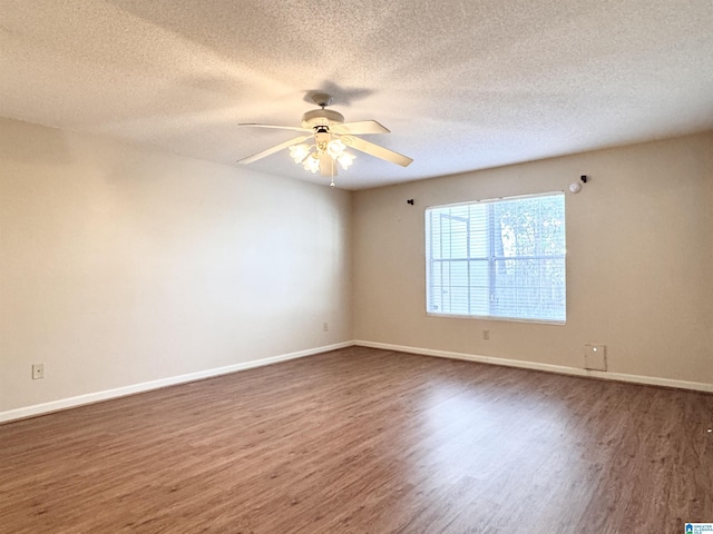 unfurnished room featuring a textured ceiling, dark hardwood / wood-style flooring, and ceiling fan