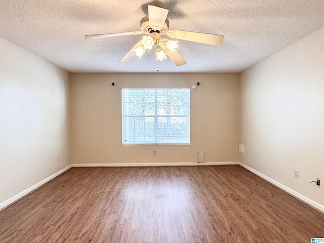 unfurnished room with a textured ceiling, ceiling fan, and dark hardwood / wood-style floors