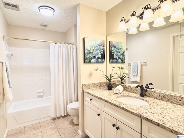 full bathroom with shower / bath combo, tile patterned floors, vanity, a textured ceiling, and toilet