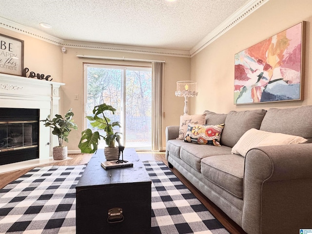 living room with hardwood / wood-style flooring, crown molding, and a textured ceiling