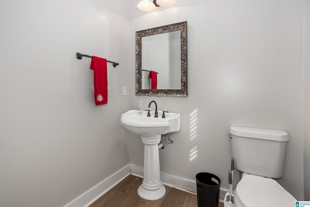 bathroom featuring toilet and wood-type flooring