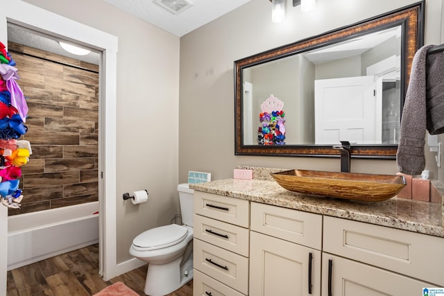 full bathroom featuring vanity, toilet, wood-type flooring, and bathing tub / shower combination