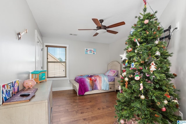 bedroom with ceiling fan and dark hardwood / wood-style flooring