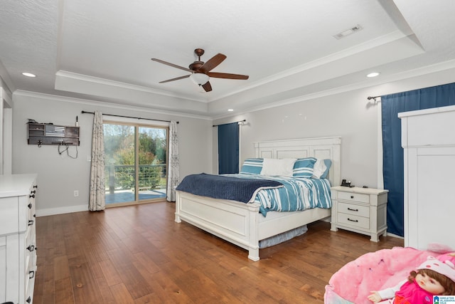 bedroom featuring dark hardwood / wood-style flooring, ceiling fan, a raised ceiling, and access to outside