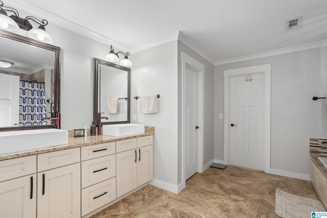 bathroom featuring vanity, a tub to relax in, ornamental molding, and a textured ceiling