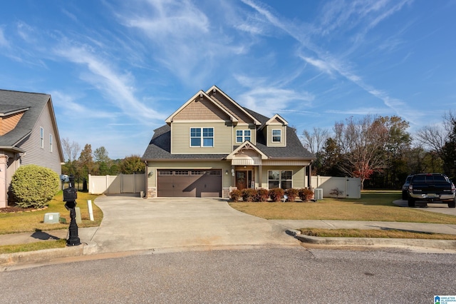 craftsman inspired home featuring a front lawn, a garage, and central AC unit