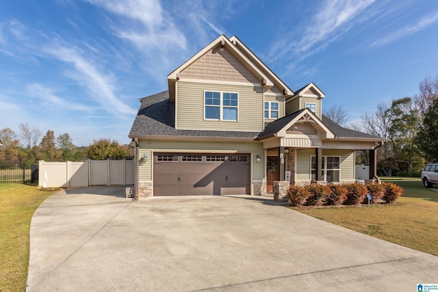 craftsman-style house featuring a front yard and a garage