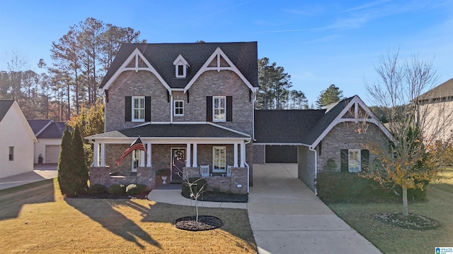 craftsman house with a front lawn, a porch, and a carport