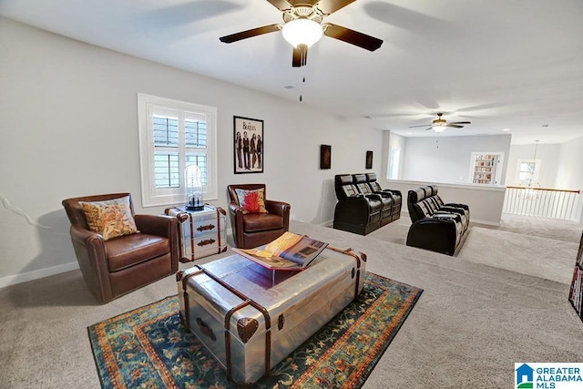 carpeted living room with ceiling fan