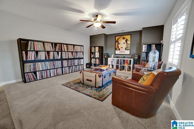 living area featuring ceiling fan and light carpet