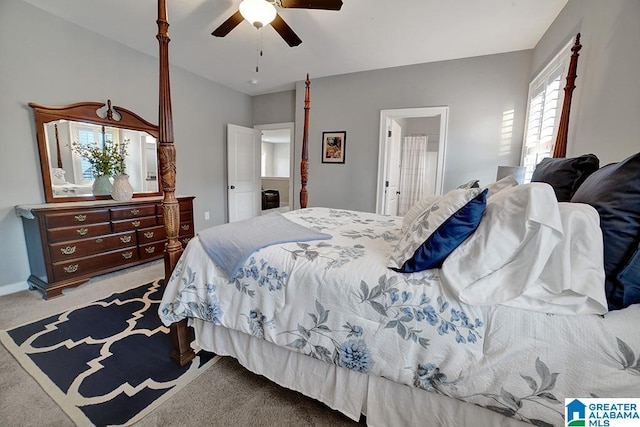 bedroom with ensuite bath, ceiling fan, and light carpet