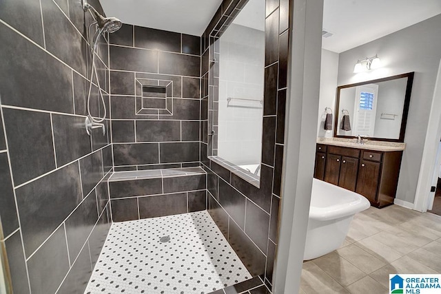 bathroom featuring tile patterned floors, vanity, and tiled shower