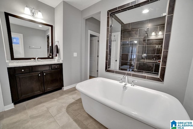 bathroom with tile patterned floors, vanity, and a bath