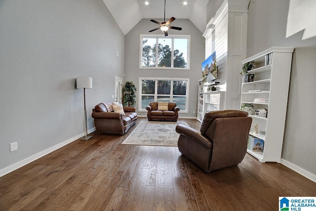 living room featuring ceiling fan, dark wood-type flooring, and high vaulted ceiling