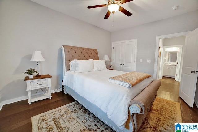 bedroom with a closet, ceiling fan, dark hardwood / wood-style flooring, and ensuite bath