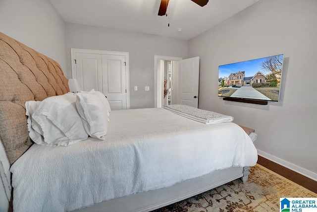 bedroom featuring ceiling fan, a closet, and hardwood / wood-style flooring