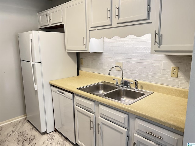 kitchen featuring tasteful backsplash, dishwashing machine, sink, and white cabinets