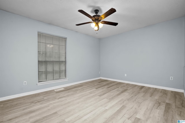 unfurnished room with ceiling fan and light hardwood / wood-style flooring