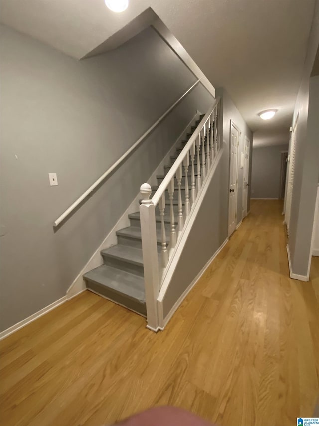 staircase featuring hardwood / wood-style flooring