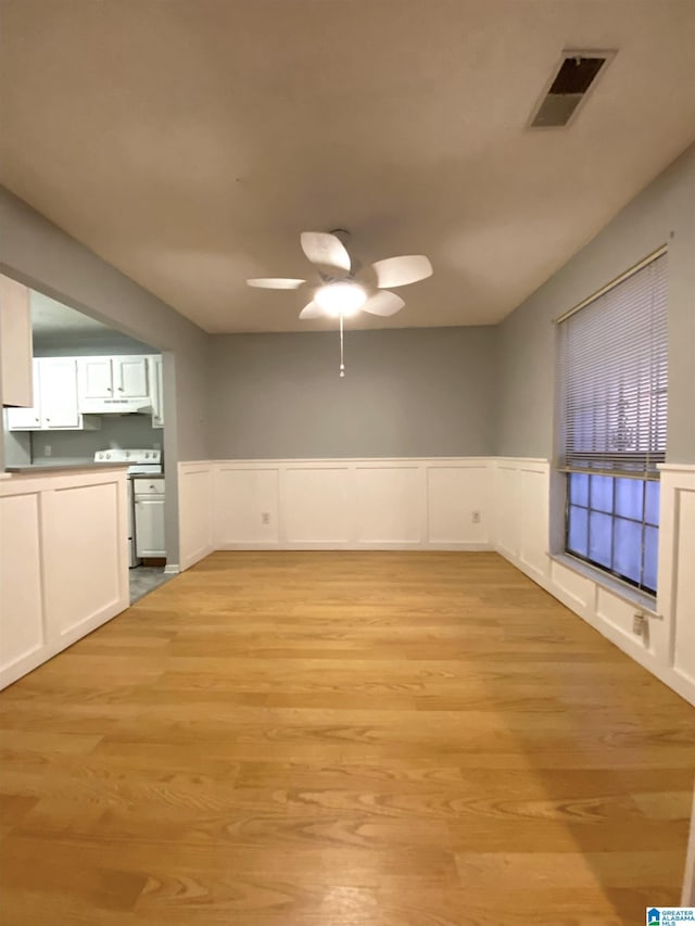 unfurnished living room featuring ceiling fan and light hardwood / wood-style flooring