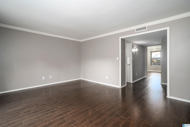 spare room featuring dark hardwood / wood-style floors and ornamental molding